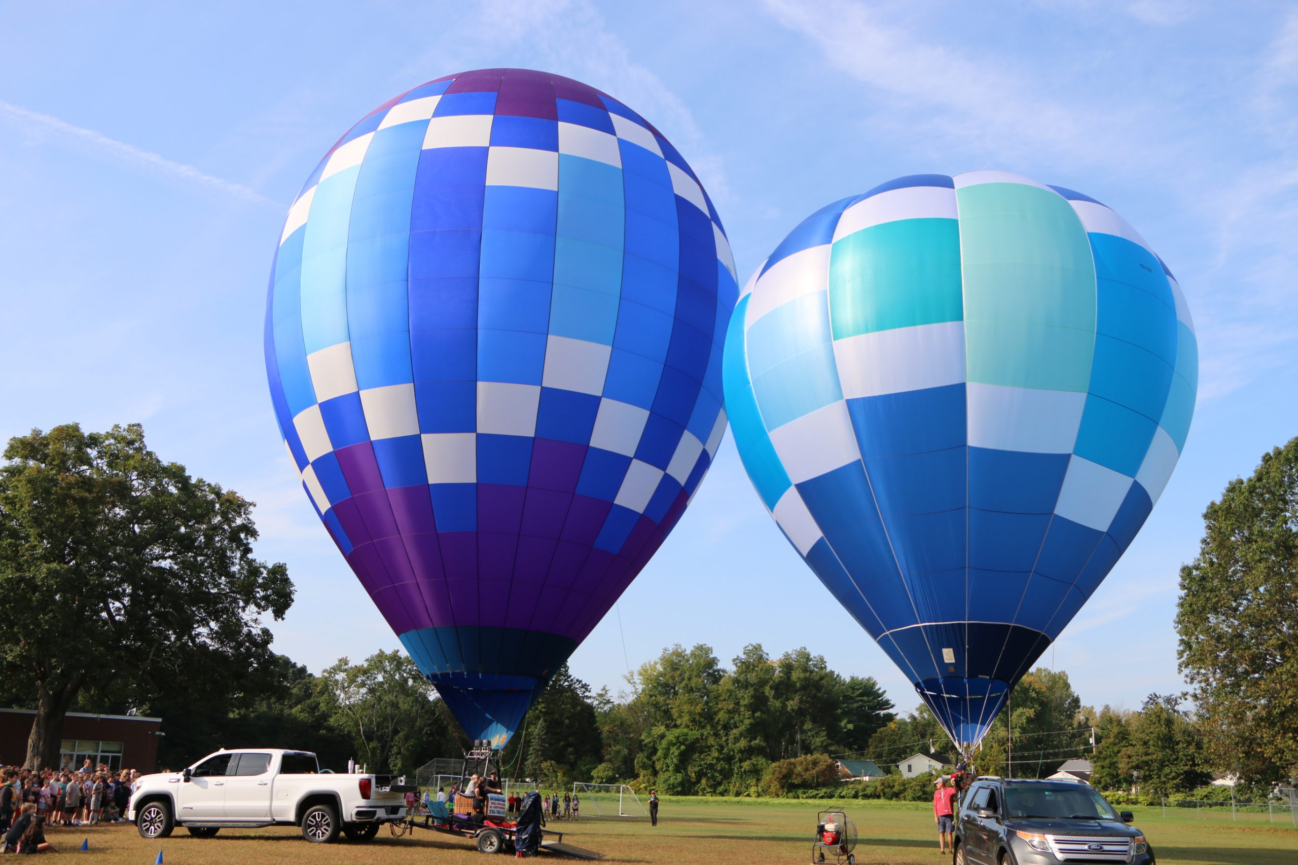 Photo of two hot air balloons inflated but grounded