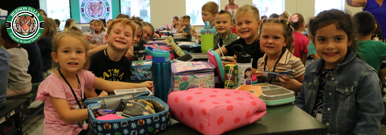 Photo of kindergartners posing at their lunch table