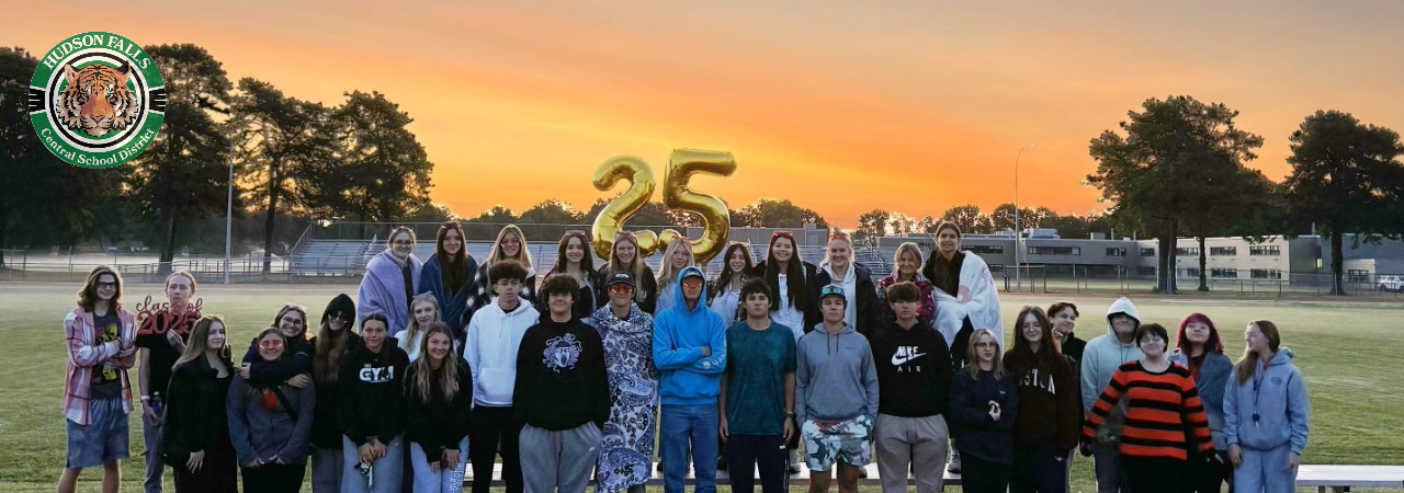 group photo of some of the class of 2025 at sunrise on the football field