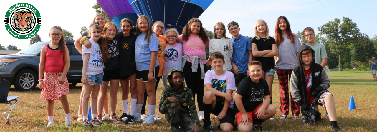 Photo of a group of students at the IS in front of a hot air balloon