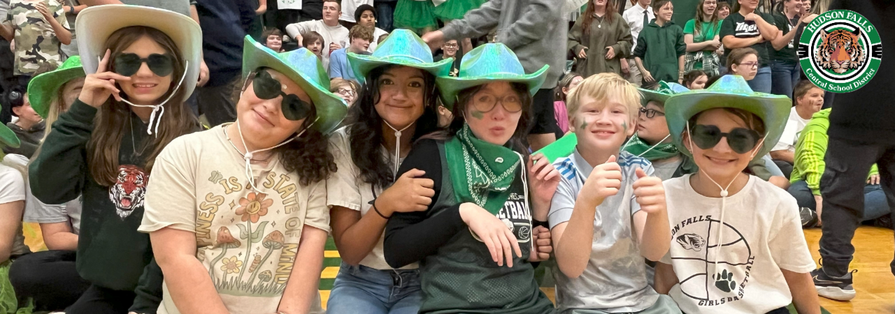 Photo of 6 middle school students wearing green hats for pep rally