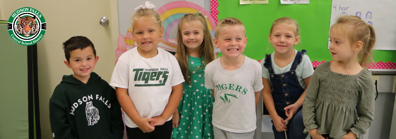 Photo of six Kindergarteners wearing Tiger gear or green for Tiger Tuesday