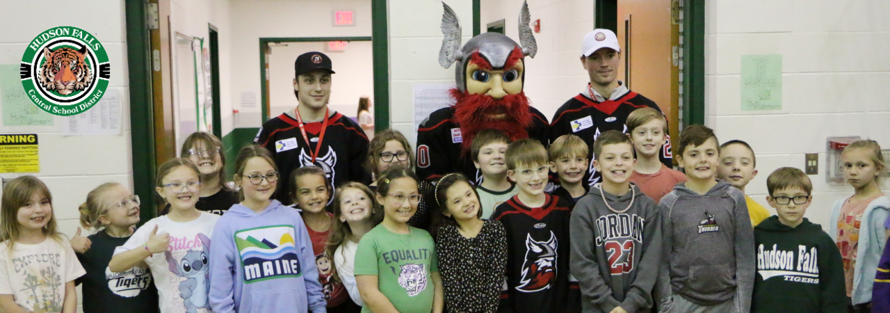 A photo of a class with two Adirondack Thunder players and the mascot Gunnar.