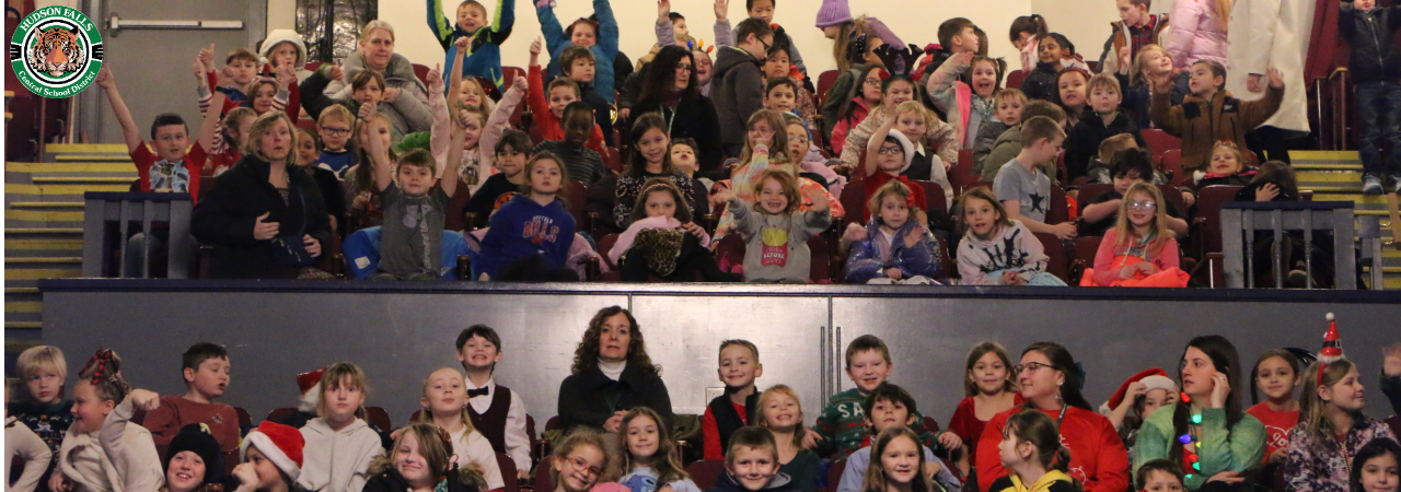 Photo of Second grade students sitting in the balcony at the Strand theatre waving to the camera