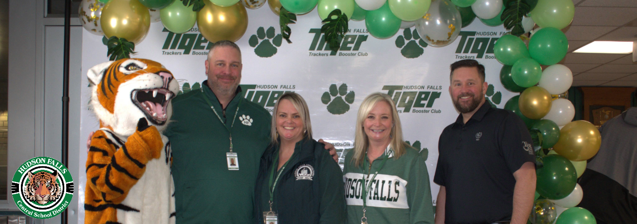 Photo of the district principals with the Tiger mascot at the green carpet event