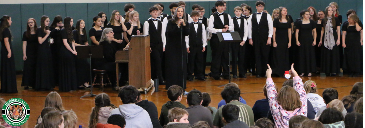 Photo of the Choraliers performing for the IS in the IS gym