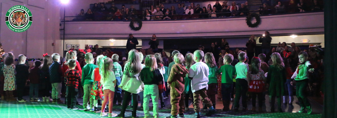 Photo from backstage of UPK students singing holiday music