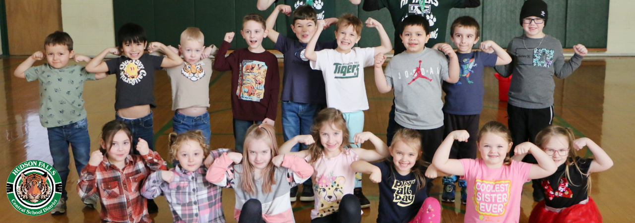 Kindergarten center PE class flexing their arms